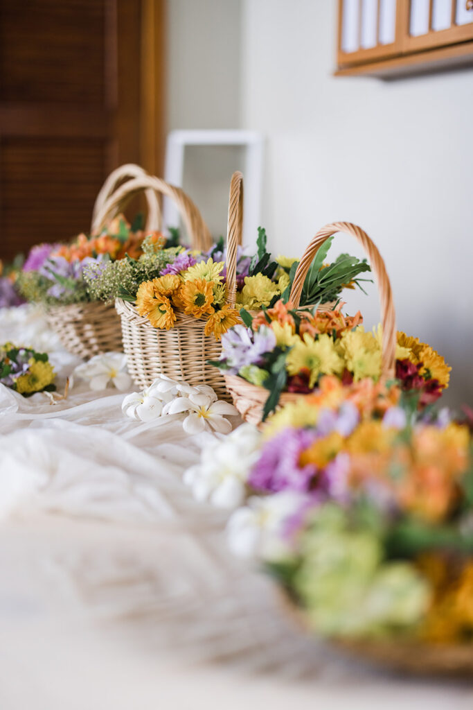 Matias Ezcurra Photography, Colorful flower baskets for a Maui wedding weekend celebration.