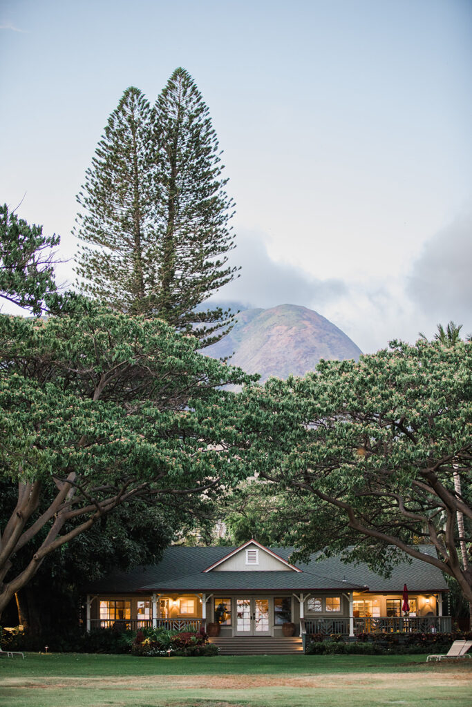 Matias Ezcurra Photography, Charming Olowalu Plantation house, Maui wedding venue, nestled amongst lush tropical trees with a mountain backdrop.