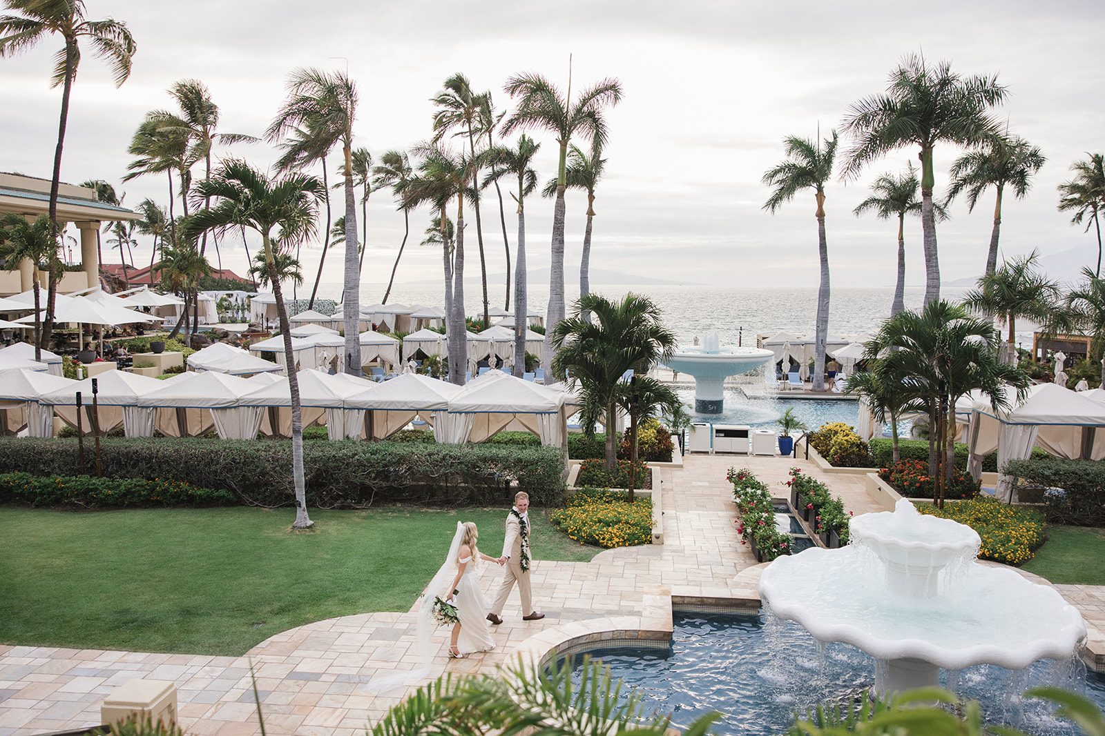 Matias Ezcurra Photography, Bride and groom walking at Four Seasons Maui wedding venue.