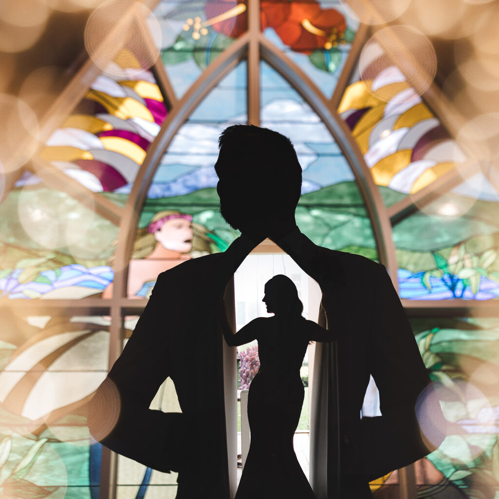 Matias Ezcurra Photography, Grand Wailea Maui wedding silhouette of couple with stained glass.
