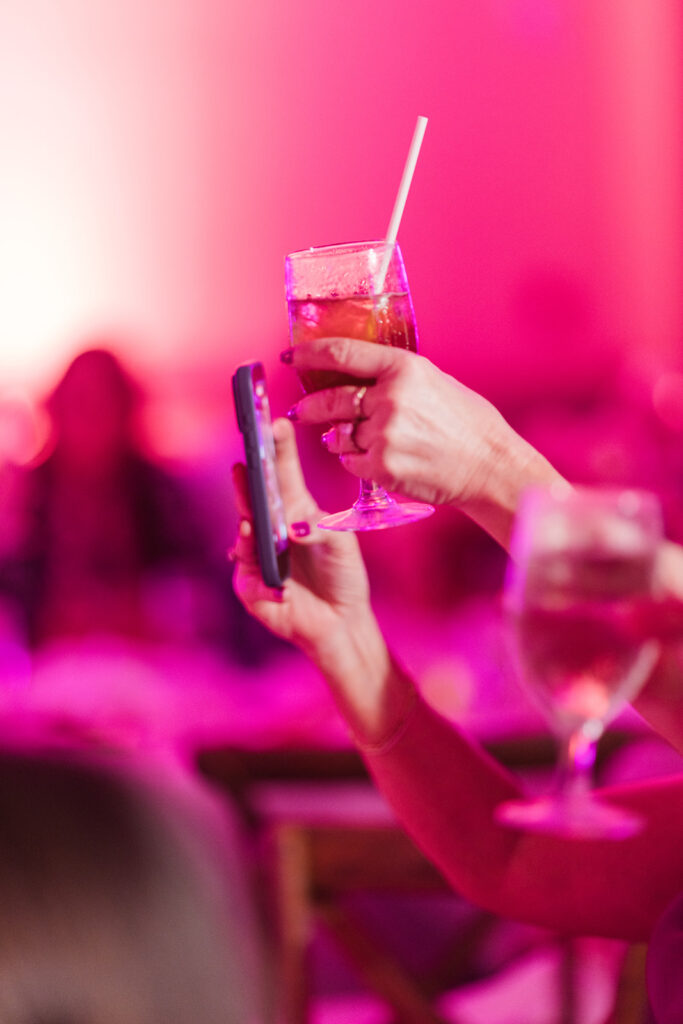 Matias Ezcurra Photography, Woman taking photo of drink at Grand Wailea Maui wedding reception.