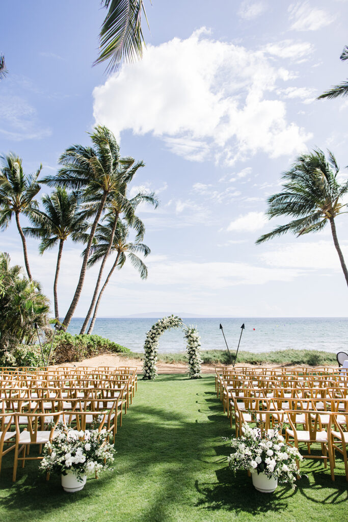 Matias Ezcurra Photography, Luxury Maui wedding venue setup with chairs and floral arch on beach