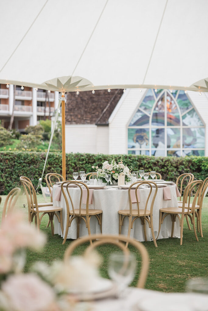 Matias Ezcurra Photography, Elegant round wedding reception table setting under a tent on Maui.
