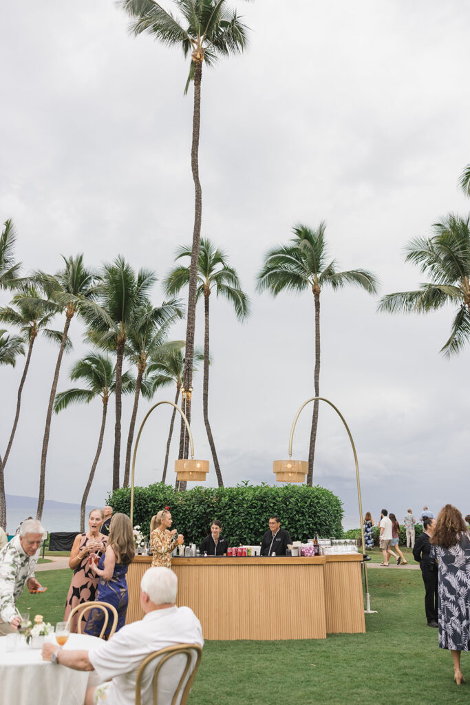 Matias Ezcurra Photography, Luxury Maui wedding bar with guests and palm trees