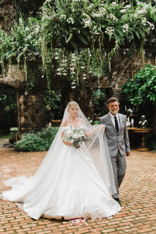 Matias Ezcurra Photography, Bride Alexandra Henkel walks down the aisle at her Haiku Mill wedding with her father, Anthony LaPaglia.