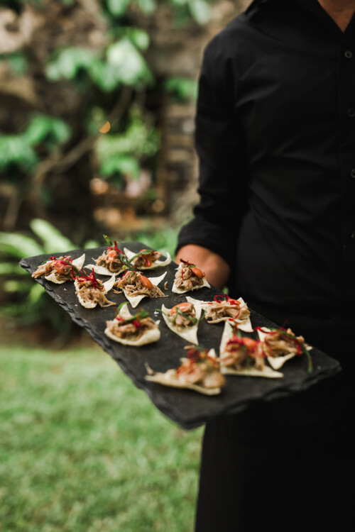 Matias Ezcurra Photography, Waiter holding a slate platter of appetizers at the Haiku Mill wedding of Anthony LaPaglia and Alexandra Henkel.