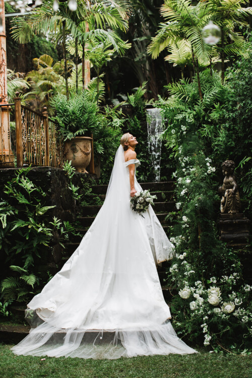Matias Ezcurra Photography, Bride in off-the-shoulder gown at Haiku Mill wedding, holding bouquet.