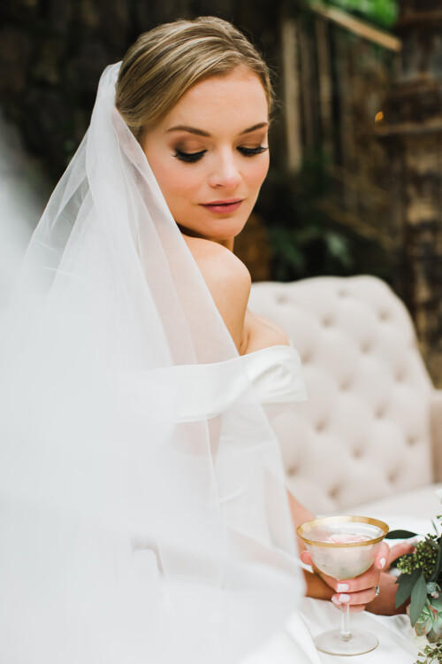 Matias Ezcurra Photography, Bride in off-the-shoulder gown holds a cocktail at her Haiku Mill wedding.