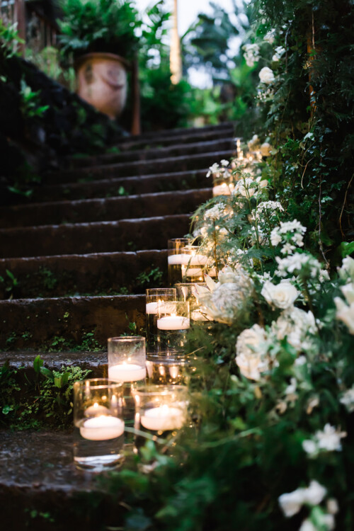 Matias Ezcurra Photography, Candles and white flowers line a stone staircase at a Haiku Mill wedding.