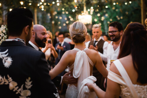 Matias Ezcurra Photography, Bride and groom dancing at their Haiku Mill wedding, surrounded by guests.