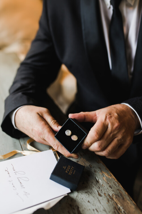 Matias Ezcurra Photography, Groom's hands holding cufflinks in a gift box at Haiku Mill wedding.