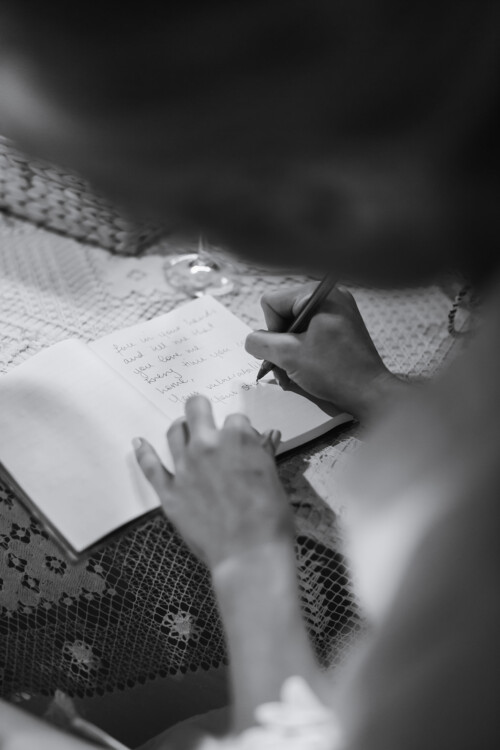 Matias Ezcurra Photography, Bride writing heartfelt message in wedding guest book at Haiku Mill wedding.