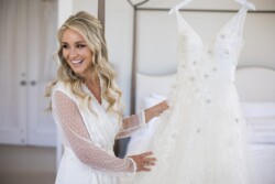 Matias Ezcurra Photography, Bride in robe admiring her wedding dress at Haiku Mill.
