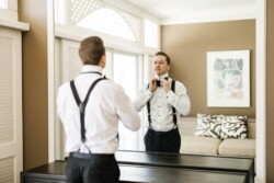 Matias Ezcurra Photography, Groom adjusting bow tie in mirror before Haiku Mill wedding.
