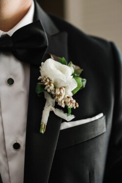 Matias Ezcurra Photography, Groom's boutonniere: white ranunculus and greenery on black tuxedo.