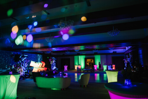 Matias Ezcurra Photography, Neon-lit wedding reception venue with lounge seating and cocktail tables.