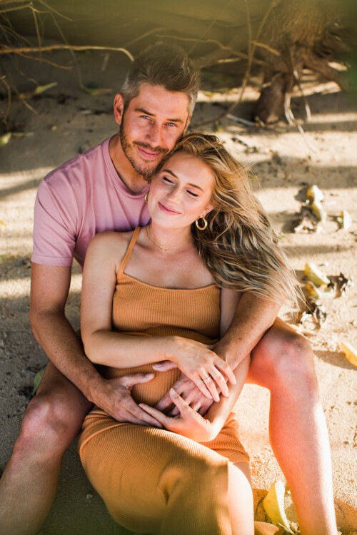 Matias Ezcurra Photography, Pregnant Lauren Luyendyk embraces Arie Luyendyk Jr. on a Maui beach.
