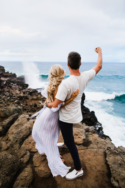 Matias Ezcurra Photography, Arie and Lauren embrace on a Maui cliff overlooking ocean waves.