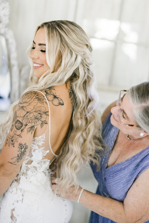 Matias Ezcurra Photography, Bride with floral tattoo getting dressed for Haiku Mill wedding
