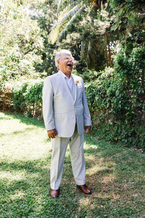 Matias Ezcurra Photography, Happy grandfather in light gray suit at Haiku Mill wedding.