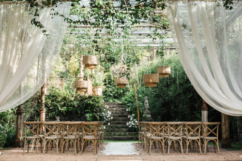 Matias Ezcurra Photography, Rustic outdoor wedding ceremony at Haiku Mill, featuring wooden chairs and a flower-petal aisle.