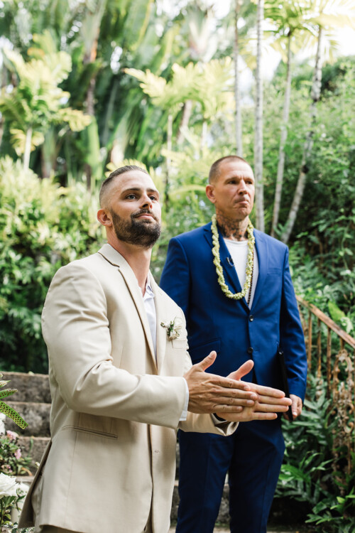 Matias Ezcurra Photography, Groom in beige suit at Haiku Mill wedding, officiant in blue suit behind him.