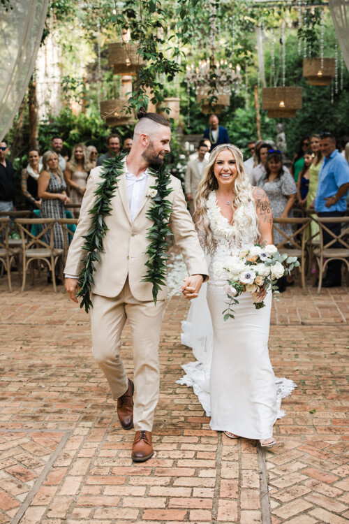 Matias Ezcurra Photography, Happy couple, Jessica & Mike, holding hands and walking down the aisle at their Haiku Mill wedding.
