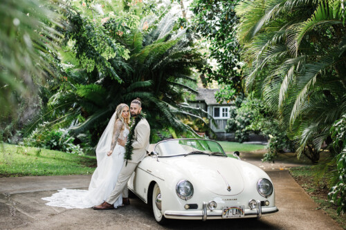 Matias Ezcurra Photography, Bride and groom pose by vintage Porsche at Haiku Mill wedding.