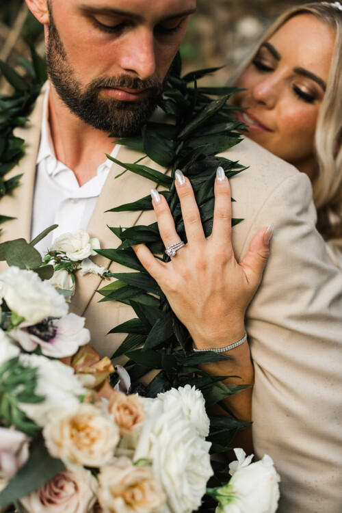 Matias Ezcurra Photography, Close-up of bride's hand on groom's shoulder at Haiku Mill wedding, showcasing wedding rings.