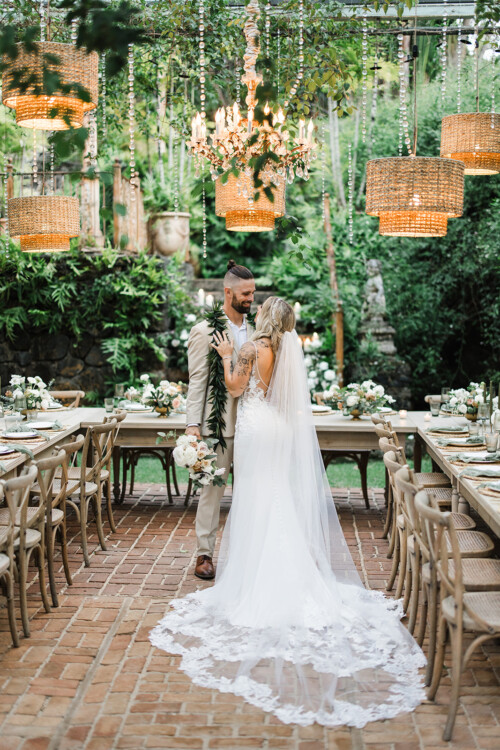 Matias Ezcurra Photography, Bride and groom at their Haiku Mill wedding reception. The happy couple stands amidst lush greenery and elegant lighting.