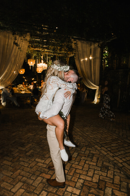 Matias Ezcurra Photography, Bride and groom embrace at their Haiku Mill wedding reception.