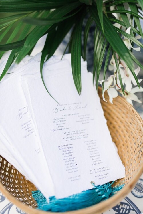 Matias Ezcurra Photography, Wedding ceremony programs in a basket at Brooke & Brad's Olowalu Plantation wedding.