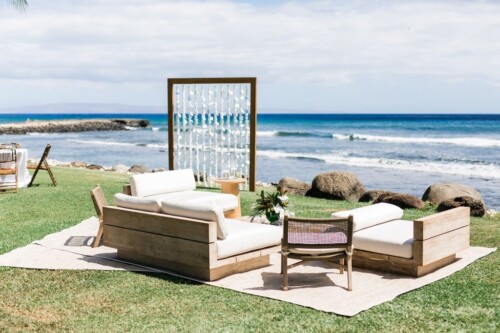 Matias Ezcurra Photography, Beachfront lounge seating at an Olowalu Plantation wedding, featuring a wooden frame with white fabric accents.