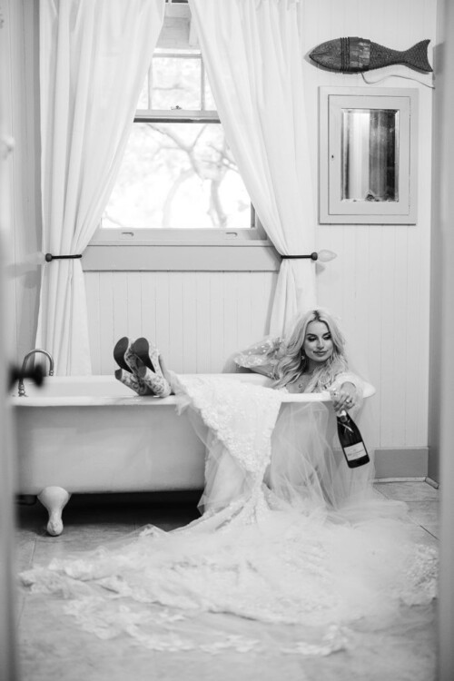 Matias Ezcurra Photography, Bride in wedding dress relaxing in bathtub with champagne, Olowalu Plantation wedding.