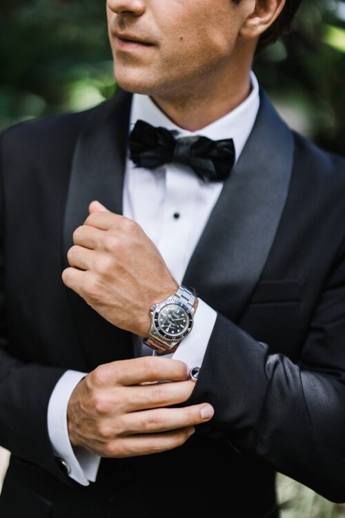 Matias Ezcurra Photography, Groom adjusting cufflinks and watch at Olowalu Plantation wedding.