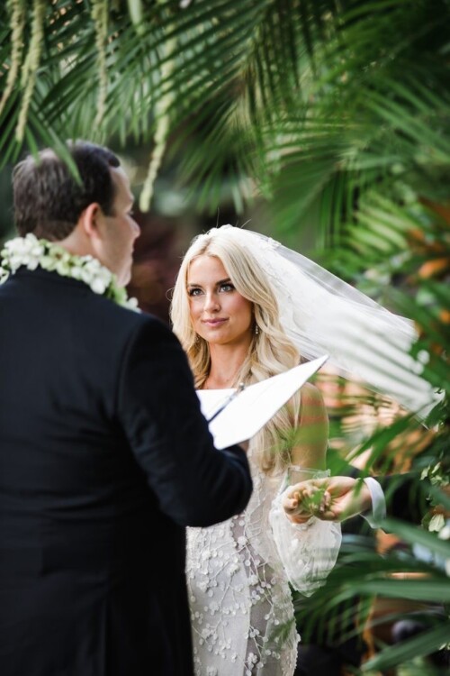 Matias Ezcurra Photography, Bride and groom exchanging vows at their Olowalu Plantation wedding. The bride wears a stunning lace gown.