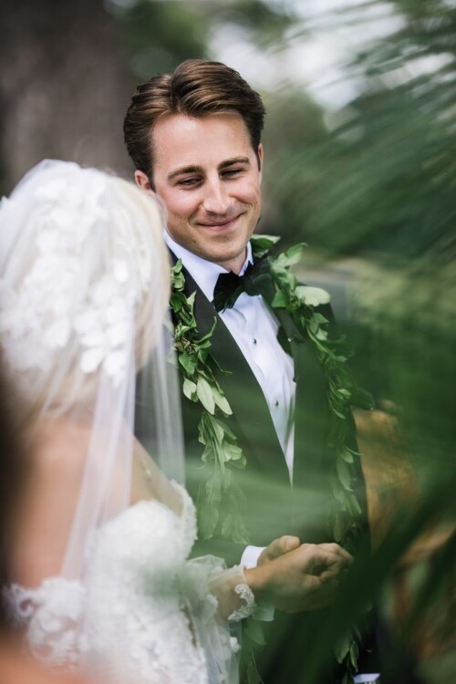 Matias Ezcurra Photography, Groom smiles at bride during Olowalu Plantation wedding ceremony.
