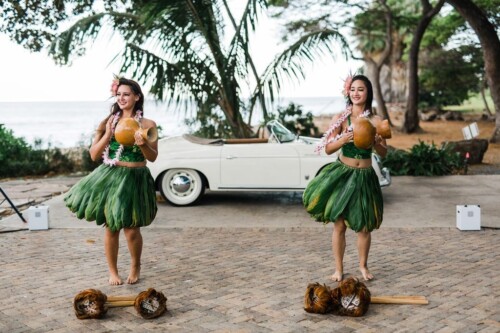 Matias Ezcurra Photography, Two hula dancers perform at an Olowalu Plantation wedding, holding ipu hekes.