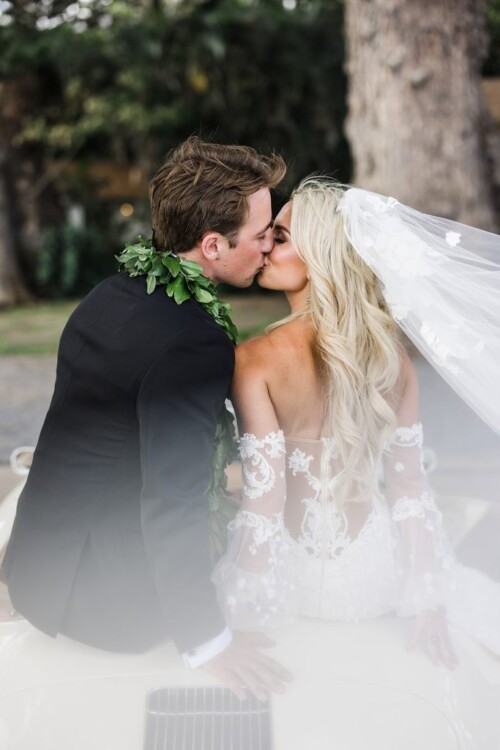 Matias Ezcurra Photography, Bride and groom kissing on vintage car, Olowalu Plantation wedding.