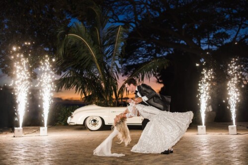 Matias Ezcurra Photography, Bride and groom dip dancing at night, sparklers surrounding them at their Olowalu Plantation wedding.