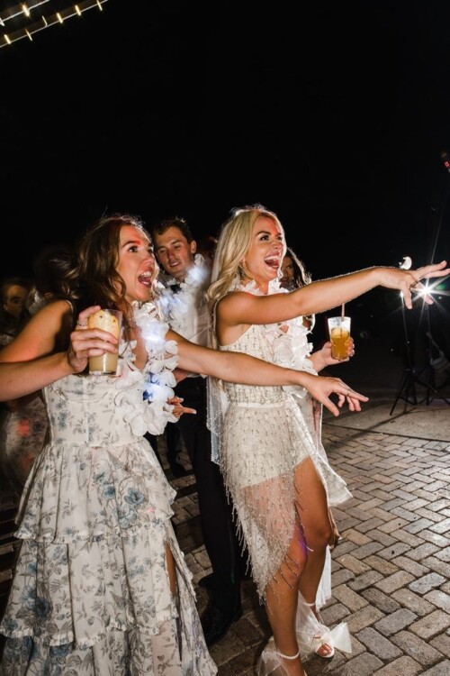 Matias Ezcurra Photography, Joyful wedding guests dance at Brooke + Sam's Olowalu Plantation wedding reception.