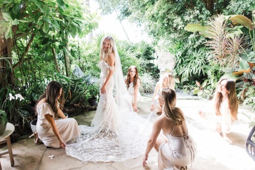 Matias Ezcurra Photography, Bride and bridesmaids prepare for wedding in lush garden.