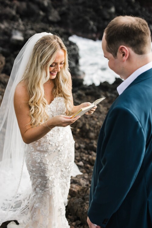 Matias Ezcurra Photography, Bride in lace wedding dress reads vows to groom during outdoor ceremony.