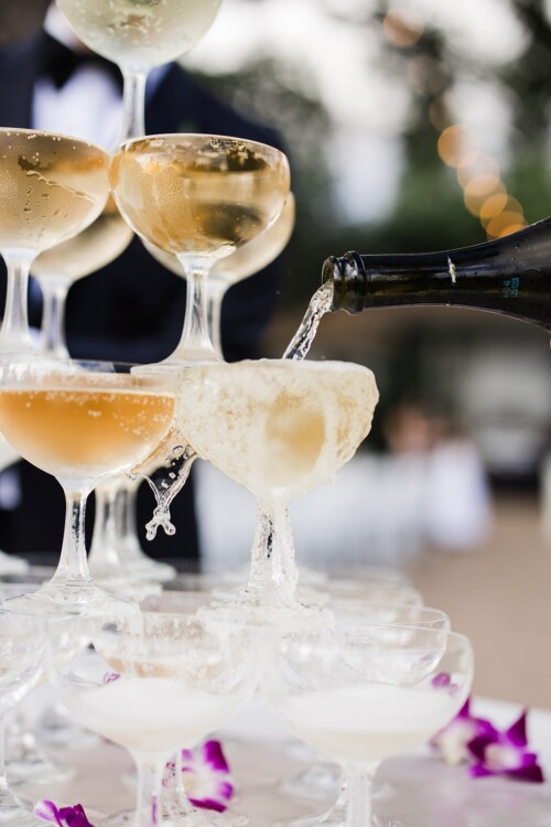 Matias Ezcurra Photography, Champagne pyramid being filled at a wedding reception