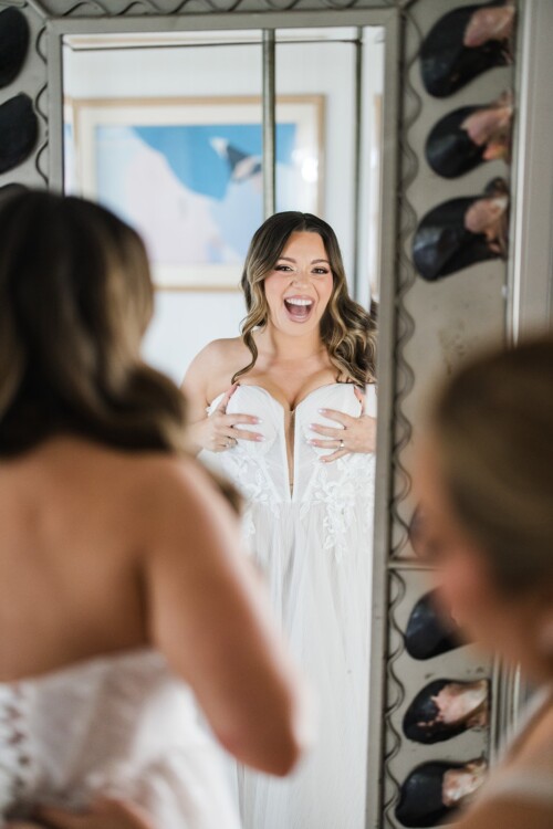 Matias Ezcurra Photography, Bride laughing while putting on her wedding dress at Olowalu Plantation House.