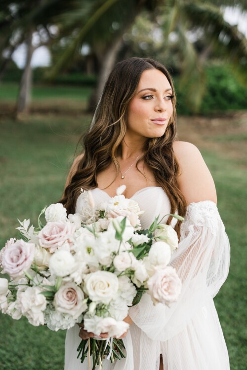 Matias Ezcurra Photography, Bride in off-the-shoulder gown holds a lush bouquet at Olowalu Plantation House.