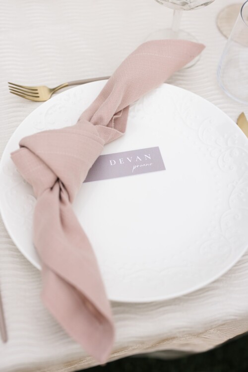 Matias Ezcurra Photography, Place setting with pink napkin, "Devan" place card, and white plate at Olowalu Plantation House wedding.