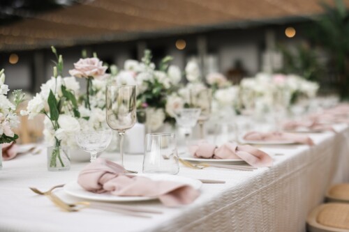 Matias Ezcurra Photography, Elegant wedding reception table setting at Olowalu Plantation House with blush pink napkins and gold flatware.