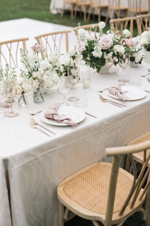 Matias Ezcurra Photography, Elegant wedding reception table setting at Olowalu Plantation House with blush pink napkins and white flowers.