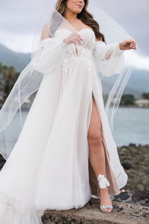 Matias Ezcurra Photography, Bride in off-the-shoulder wedding gown with long sleeves and high slit at Olowalu Plantation House.